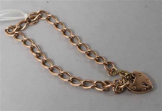 A late Victorian 9ct gold curb link bracelet with heart shaped padlock by E. Whitehouse & Son.